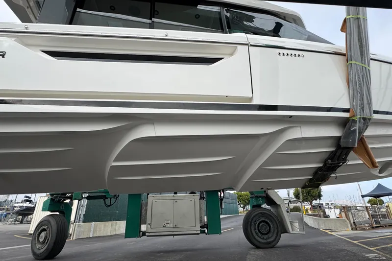 Slide: The Image of 2026 Saxdor 400 GTC boat hull on a trailer at a marina. - 59