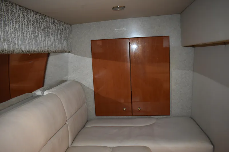 Slide: The Image of 2004 Formula 34 PC cabin interior with beige seating and wooden cabinets. - 17