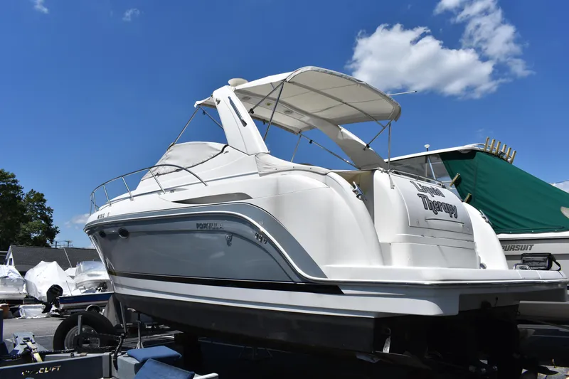 Slide: The Image of 2004 Formula 34 PC boat on trailer under blue sky with clouds. - 2