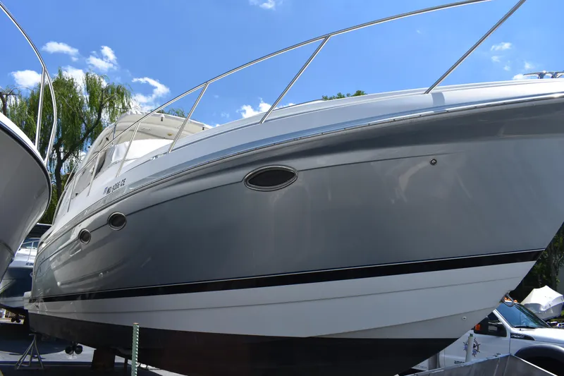 Slide: The Image of 2004 Formula 34 PC boat with sleek design, docked under a clear blue sky. - 4