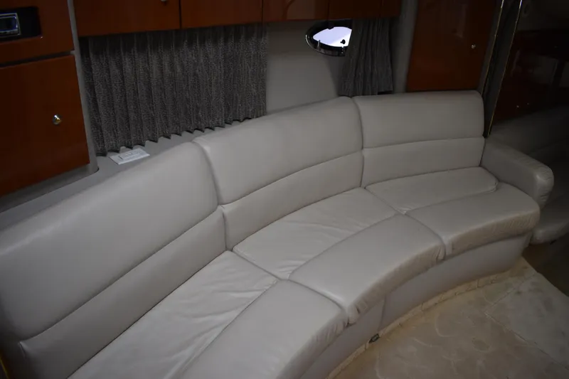 Slide: The Image of 2004 Formula 34 PC yacht interior with curved leather seating and wooden cabinetry. - 7