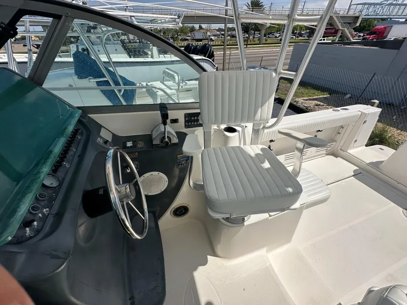 Slide: The Image of 1998 Trophy 2902 Walkaround boat cockpit with steering wheel and seating. - 10