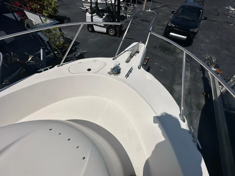 Slide: The Image of 1998 Trophy 2902 Walkaround boat deck with railing and anchor. - 13