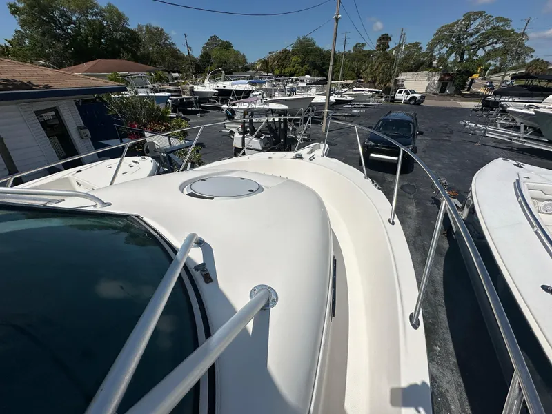 Slide: The Image of 1998 Trophy 2902 Walkaround boat docked in a marina, view from the bow. - 14