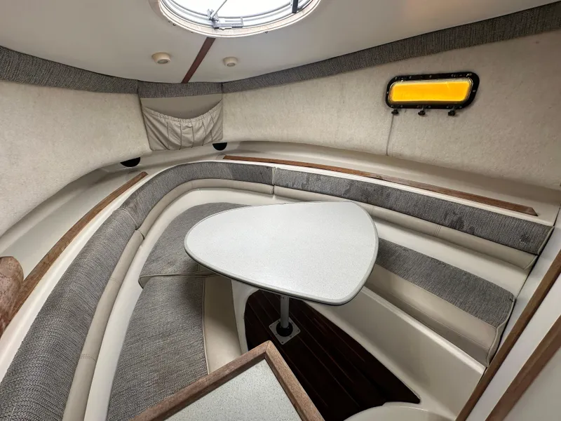 Slide: The Image of 1998 Trophy 2902 Walkaround cabin interior with seating and table. - 16