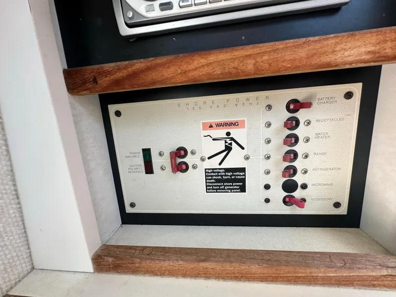 Slide: The Image of Control panel of a 1998 Trophy 2902 Walkaround boat with warning label and switches. - 17