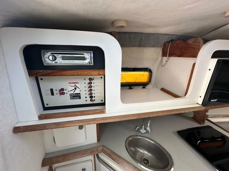 Slide: The Image of 1998 Trophy 2902 Walkaround boat interior control panel and sink. - 18