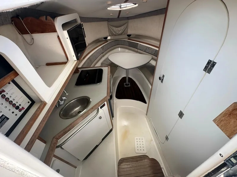 Slide: The Image of 1998 Trophy 2902 Walkaround cabin interior with kitchenette and seating area. - 20