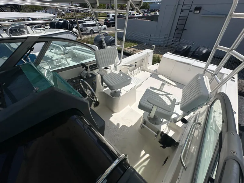 Slide: The Image of 1998 Trophy 2902 Walkaround boat cockpit with seating and steering wheel. - 4