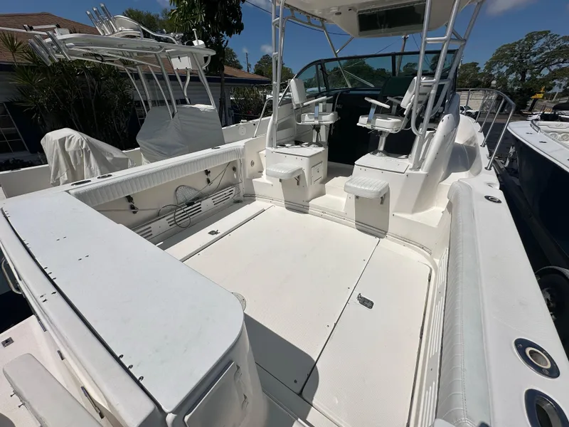 Slide: The Image of 1998 Trophy 2902 Walkaround boat with spacious deck and seating area. - 6