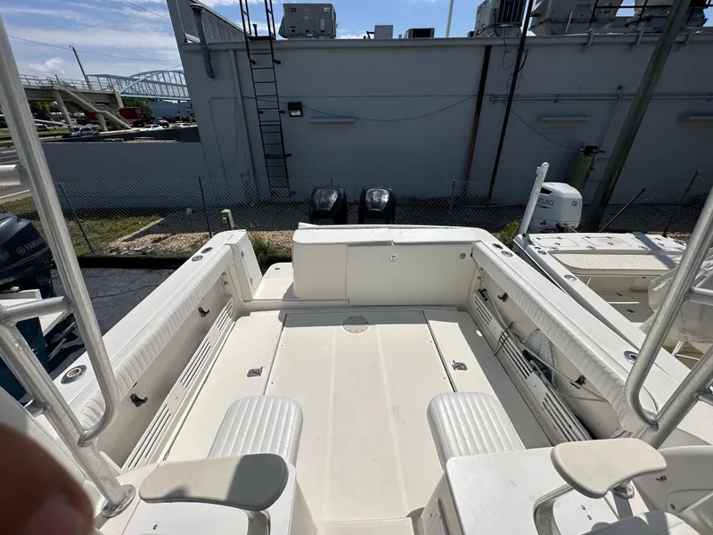 Slide: The Image of 1998 Trophy 2902 Walkaround boat deck with seating and storage compartments. - 8