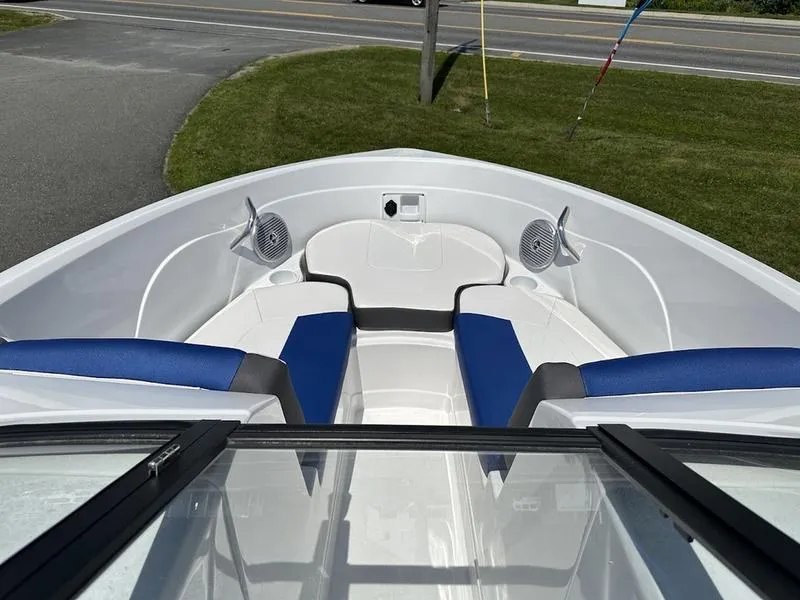 Slide: The Image of 2024 Tahoe 200 S boat bow seating area with blue and white upholstery. - 2