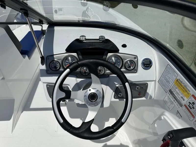 Slide: The Image of 2024 Tahoe 200 S boat dashboard with steering wheel and control gauges. - 3