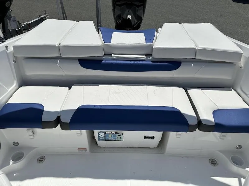 Slide: The Image of 2024 Tahoe 200 S boat with white and blue cushioned seating. - 5