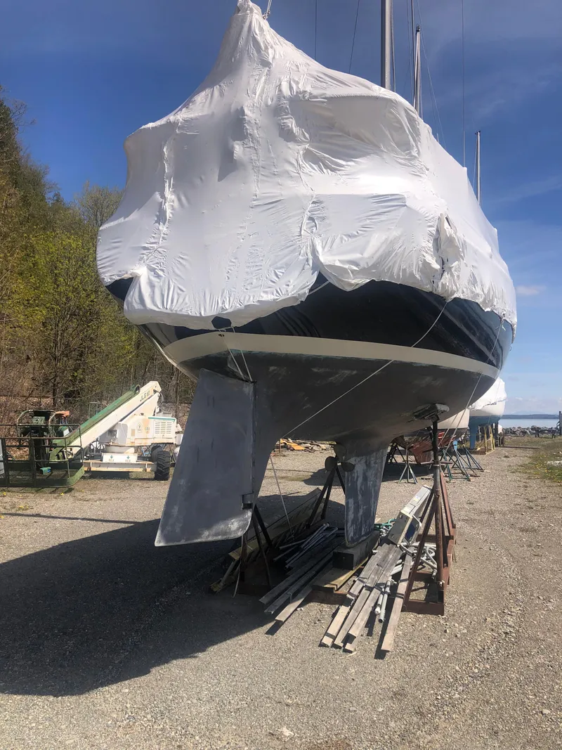 Slide: The Image of 1974 Tartan 30 sailboat covered in protective wrap, stored on land. - 19