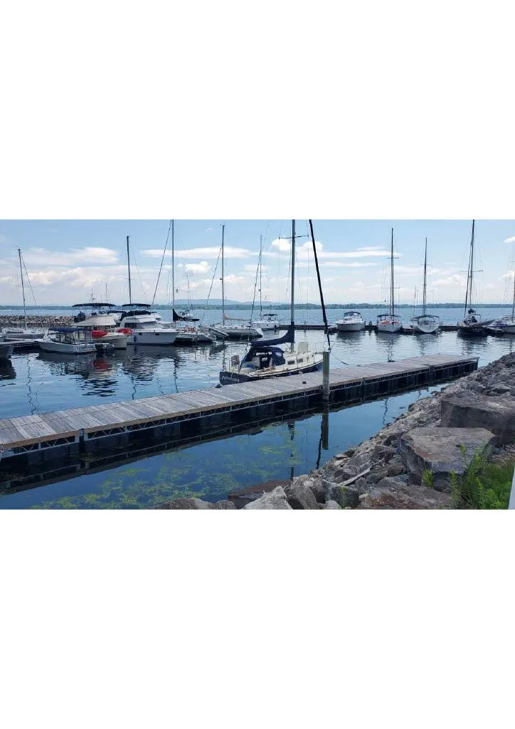 Slide: The Image of 1974 Tartan 30 sailboats docked at a marina on a clear day. - 2