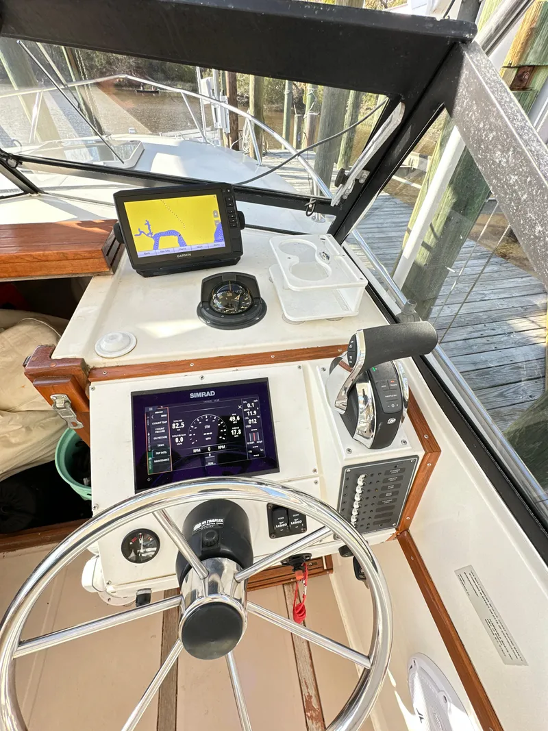 Slide: The Image of 1988 Albemarle 24 boat helm with modern navigation equipment. - 10