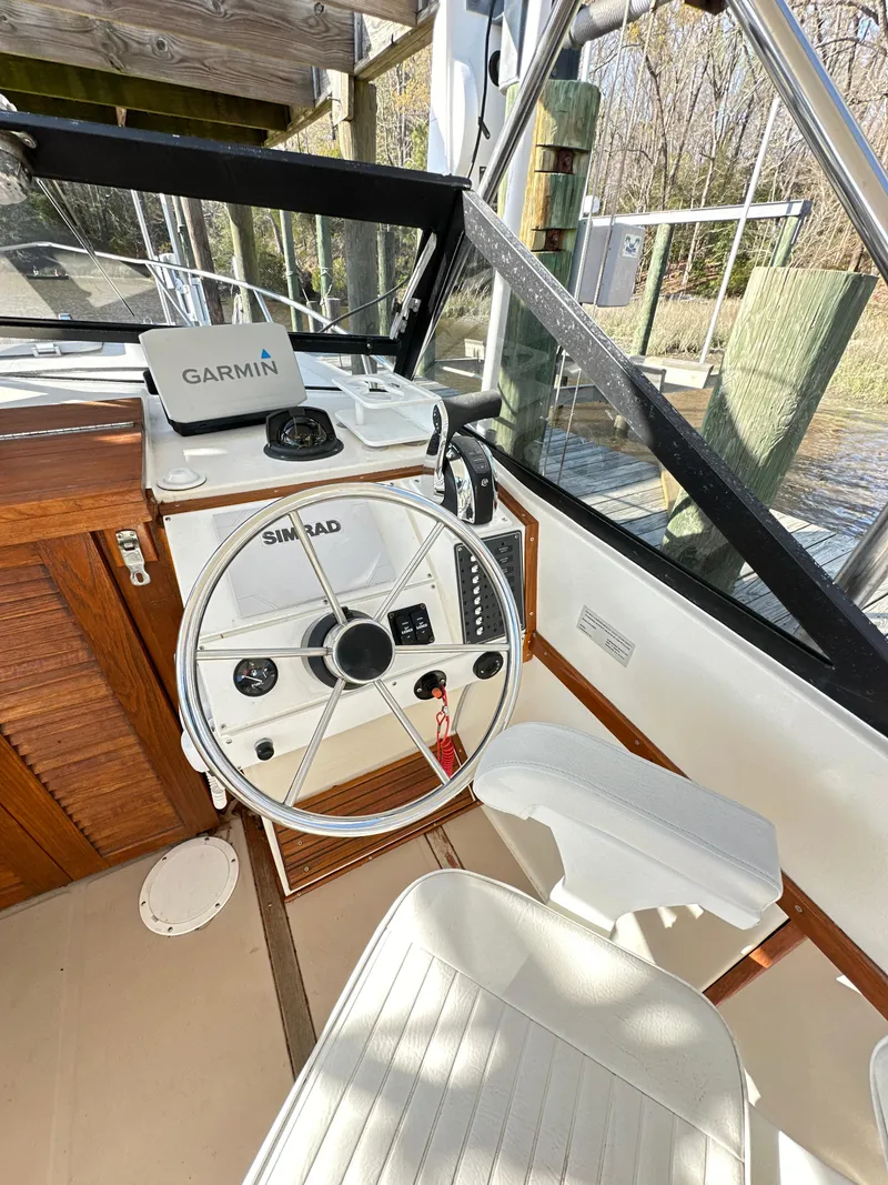 Slide: The Image of 1988 Albemarle 24 boat helm with Garmin and Simrad navigation systems. - 11