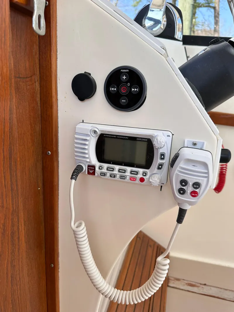 Slide: The Image of VHF radio and controls on 1988 Albemarle 24 boat dashboard. - 13