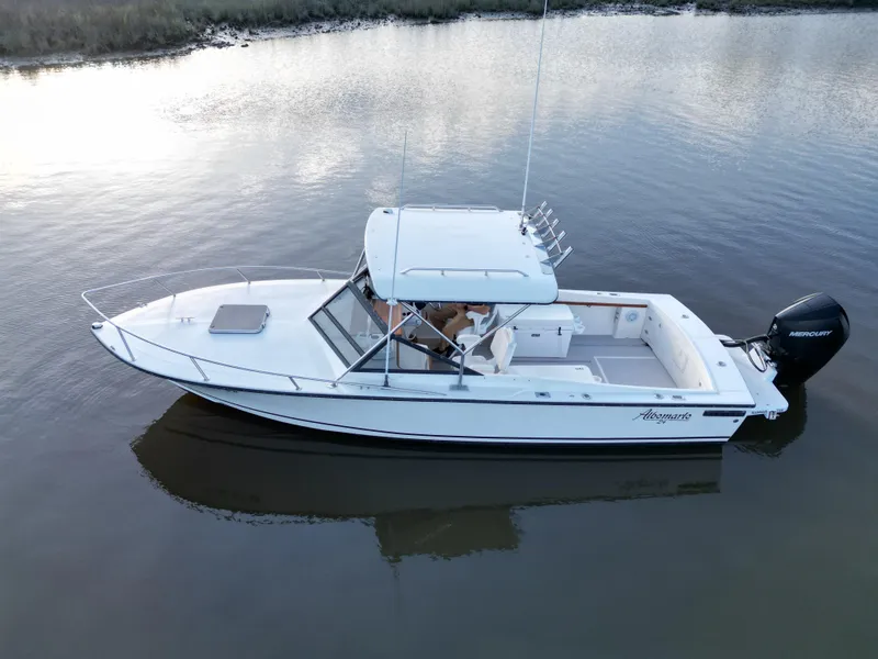 Slide: The Image of 1988 Albemarle 24 boat on calm water with outboard motor. - 3