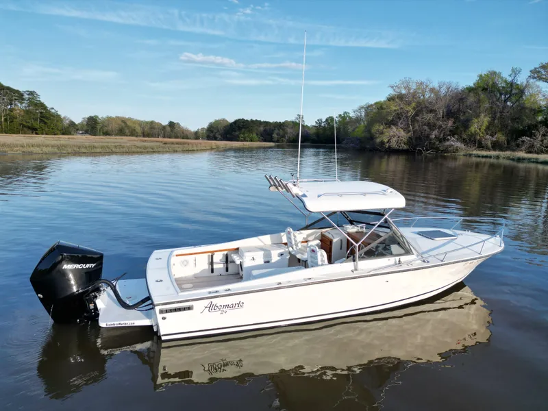 Slide: The Image of 1988 Albemarle 24 boat on calm water with Mercury outboard motor. - 4