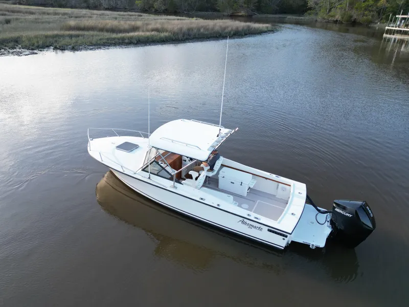 Slide: The Image of 1988 Albemarle 24 boat on calm river water. - 5