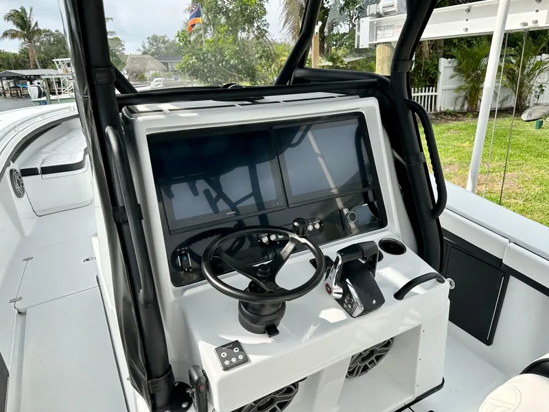 Slide: The Image of 2024 Yellowfin 36 boat dashboard with dual screens and steering wheel. - 11