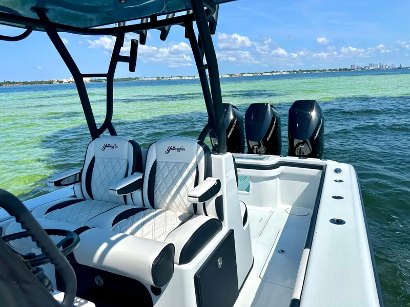 Slide: The Image of 2024 Yellowfin 36 boat with triple outboard engines on clear blue water. - 4