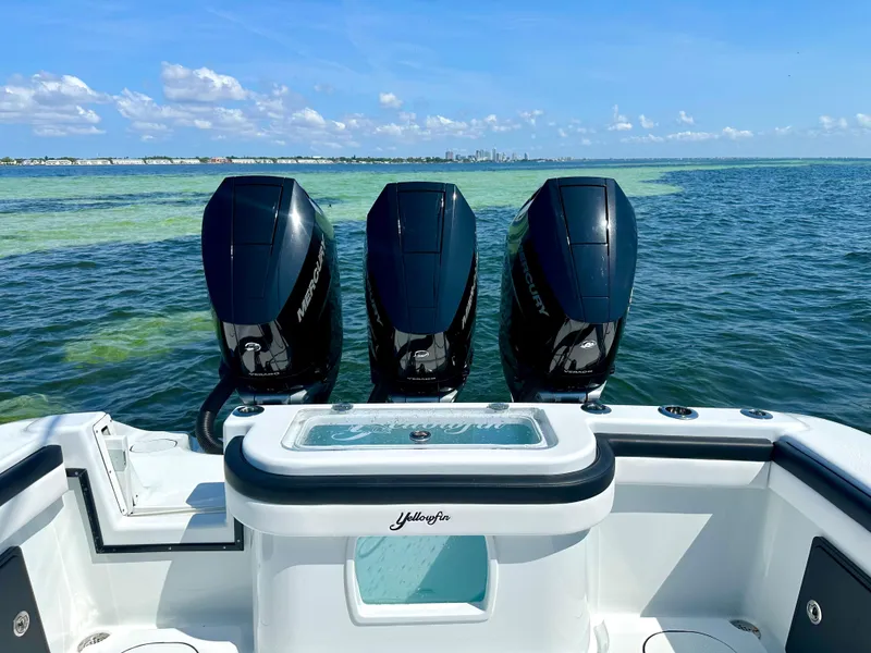 Slide: The Image of 2024 Yellowfin 36 boat with triple outboard motors on the water. - 5