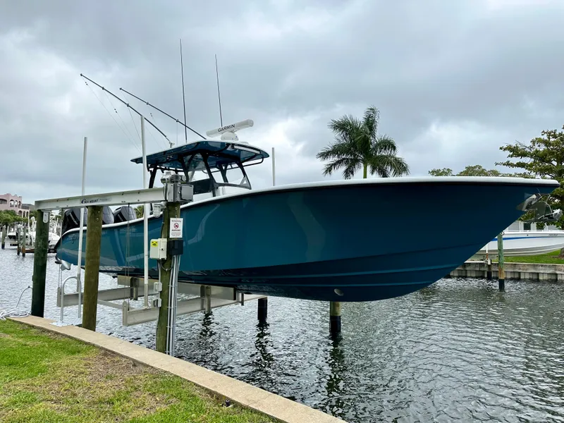 Slide: The Image of 2024 Yellowfin 36 boat docked on a lift by the water. - 7