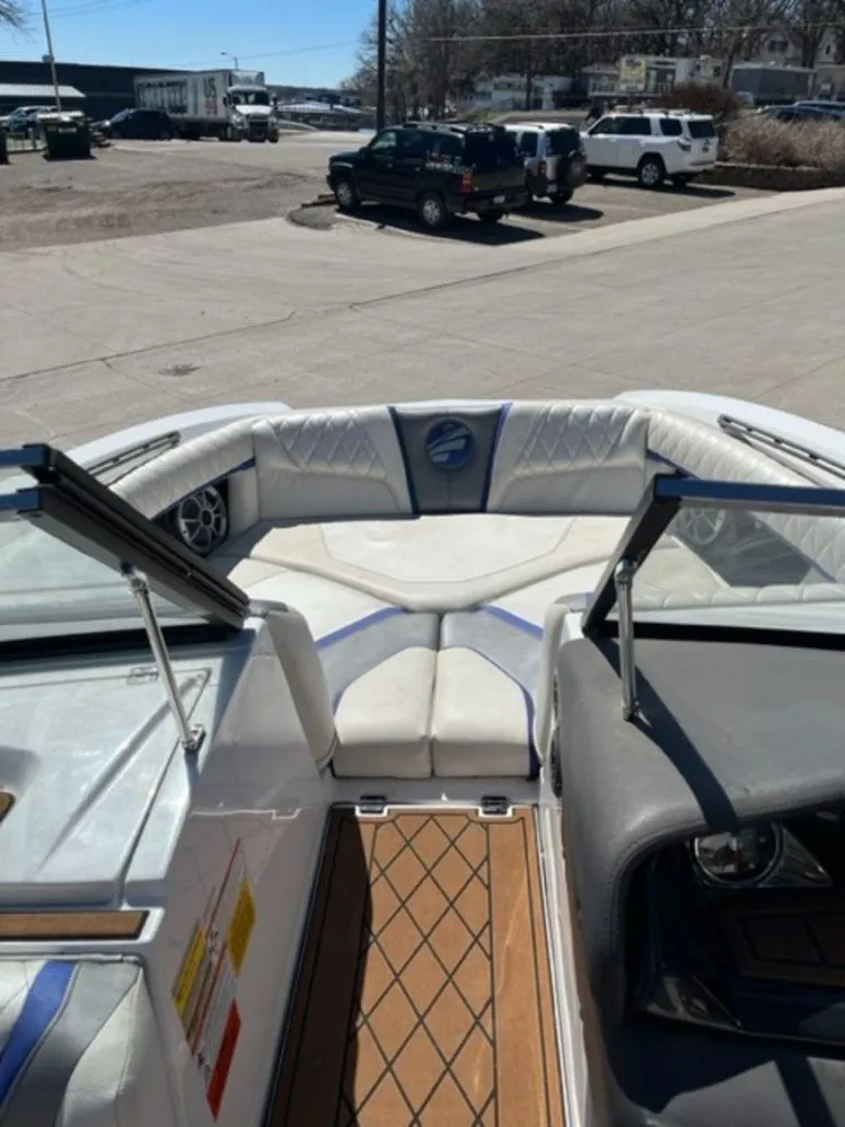 Slide: The Image of 2016 Tigé RZX boat interior with cushioned seating and wood flooring. - 12