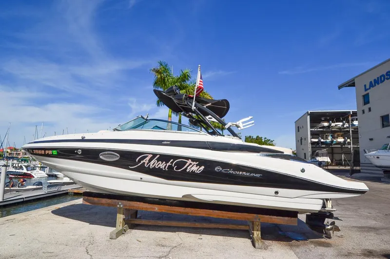 Slide: The Image of 2014 Crownline Eclipse E6 boat on a dock with blue sky background. - 0