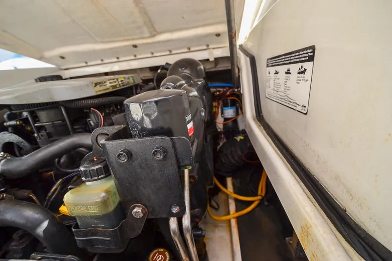 Slide: The Image of 2014 Crownline Eclipse E6 boat engine compartment with visible components and labels. - 19