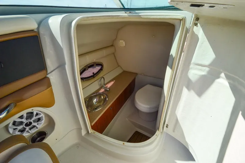 Slide: The Image of 2014 Crownline Eclipse E6 boat interior bathroom with sink and toilet. - 23