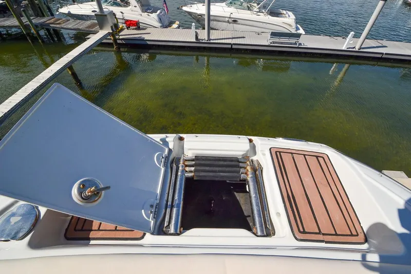 Slide: The Image of 2014 Crownline Eclipse E6 boat with open hatch and swim platform at dock. - 26