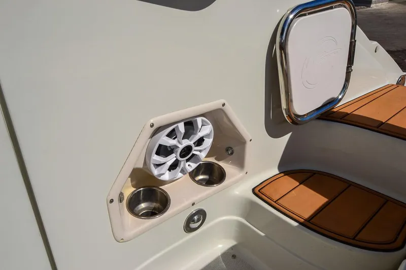 Slide: The Image of 2014 Crownline Eclipse E6 boat speaker and cup holders on deck. - 29