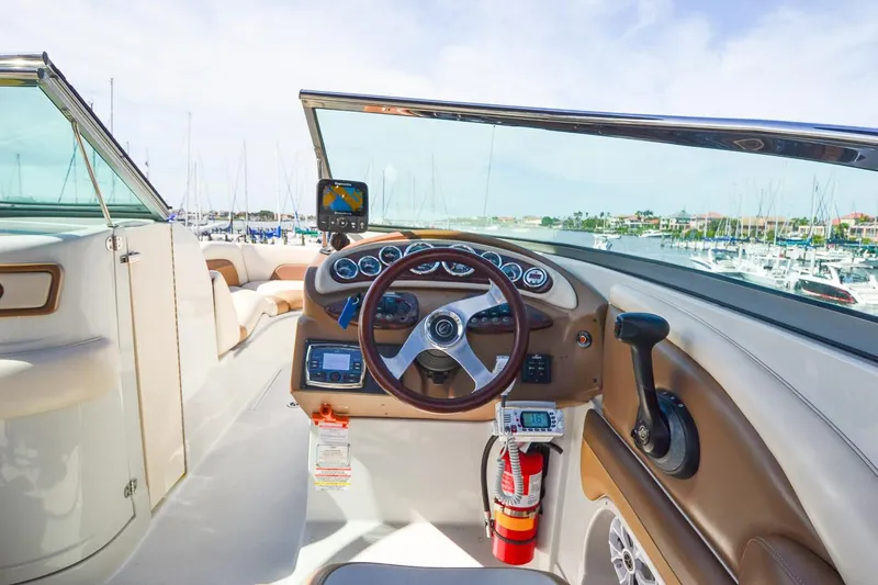 Slide: The Image of 2014 Crownline Eclipse E6 boat dashboard with steering wheel and navigation equipment. - 32
