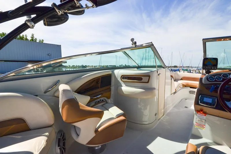 Slide: The Image of 2014 Crownline Eclipse E6 boat interior with tan and white seating. - 33