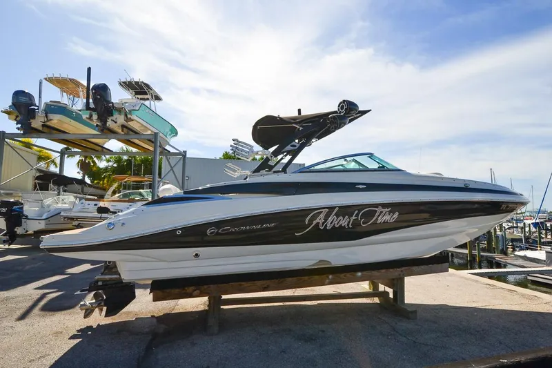 Slide: The Image of 2014 Crownline Eclipse E6 boat on a trailer at a marina. - 6