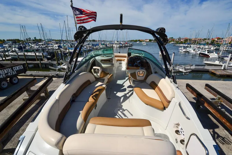 Slide: The Image of 2014 Crownline Eclipse E6 boat interior at marina with American flag. - 9