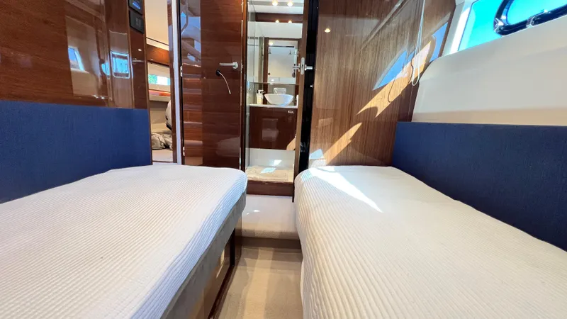 Slide: The Image of Interior of 2019 Princess F62 yacht with twin beds and wooden finishes. - 27
