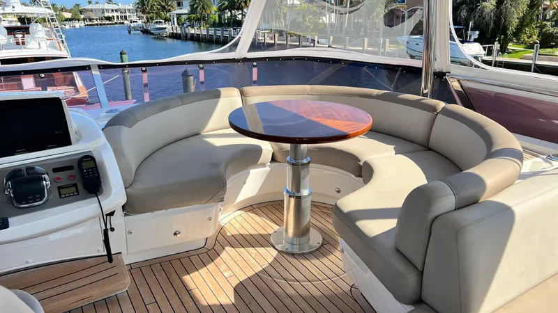 Slide: The Image of Luxurious seating area on 2019 Princess F62 yacht with wooden table and waterfront view. - 31