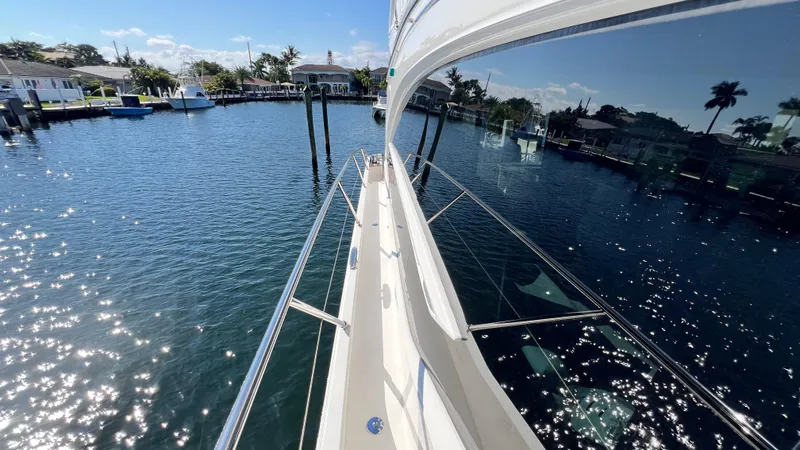 Slide: The Image of 2019 Princess F62 yacht on serene water with clear skies and reflections. - 37