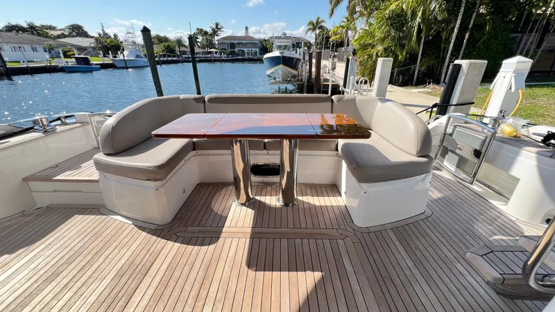 Slide: The Image of Luxurious 2019 Princess F62 yacht deck with elegant seating and wooden table by the water. - 39