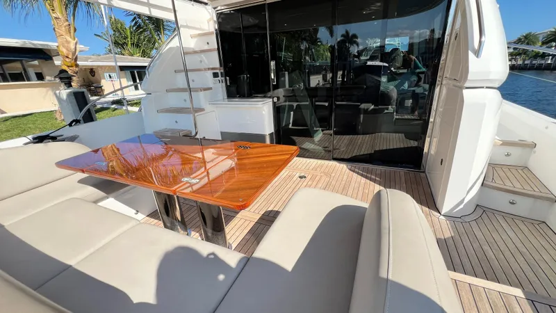 Slide: The Image of Luxury yacht Princess F62 2019, featuring elegant outdoor seating and polished wooden table. - 42