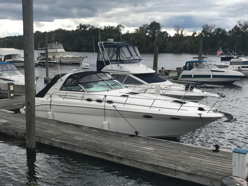 The Image of 1997 Sea Ray 370 Sundancer docked at a marina with other boats. - 0