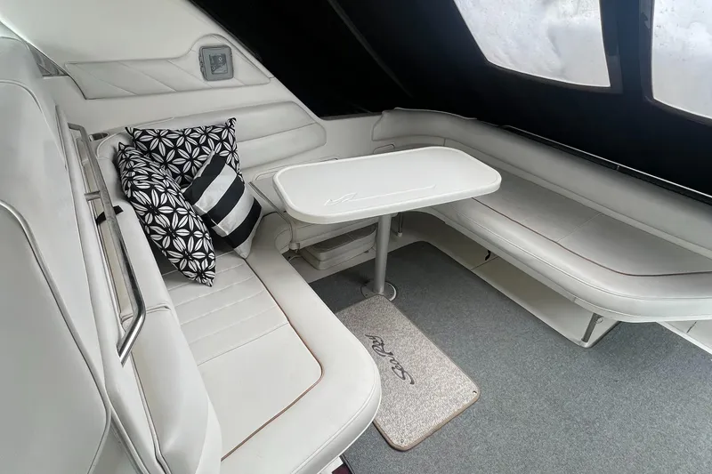 Slide: The Image of 1997 Sea Ray 370 Sundancer interior with white seating, table, and decorative pillows. - 15