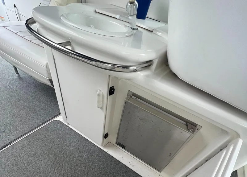 Slide: The Image of 1997 Sea Ray 370 Sundancer boat interior with sink and storage. - 18