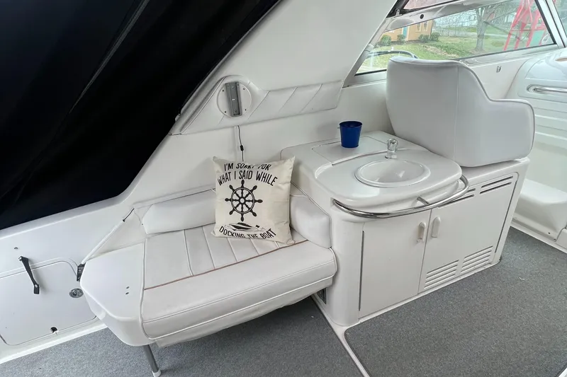 Slide: The Image of 1997 Sea Ray 370 Sundancer interior with white seating and sink. - 20