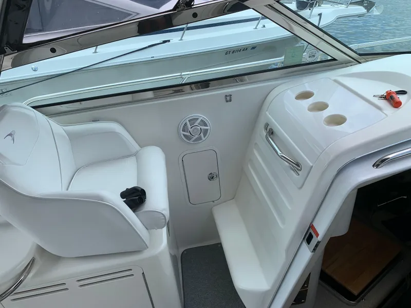 Slide: The Image of 1997 Sea Ray 370 Sundancer cockpit with white seating and control panel. - 24